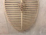 a wooden heart shaped sign hanging on the wall