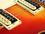 an electric guitar sitting on top of a table next to a white wall