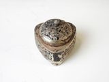 an image of a small silver box with a lid on a white surface