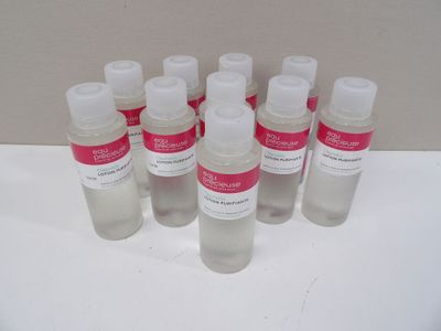 six bottles of hand sanitizer sitting on a white surface