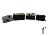 several old cameras are lined up in a row on a white surface