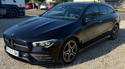 the mercedes cla is parked in a parking lot next to a truck