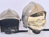 two helmets that are sitting next to each other on a white surface