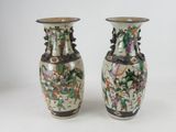 two vases sitting side by side on a white surface