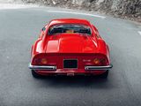 a red car that is driving down the road