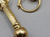 pair of antique brass door handles on a gray surface