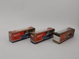 three boxes of cigarettes sitting on top of a white surface