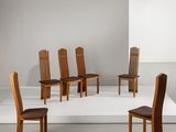 Plusieurs chaises en bois sont disposées en cercle sur une surface blanche