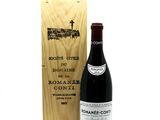 a bottle of wine sitting next to a wooden box
