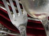 a fork and a spoon sitting on a red cloth
