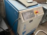 a blue machine sitting on top of a pallet in a room