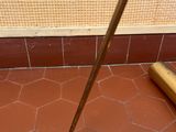 a broom on the floor next to a broom on the floor