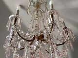 a crystal chandelier hanging from a ceiling in a room