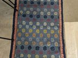 a blue rug with a red border and a yellow border