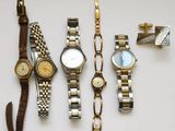 five different watches on a white table with a knife