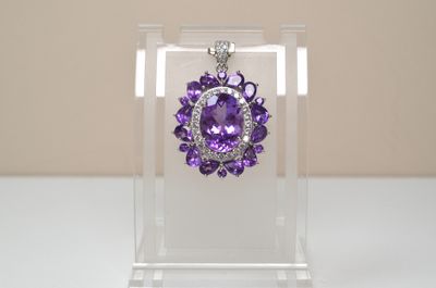 a purple necklace with a purple flower in the center