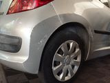 a silver car that is parked in a garage