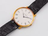 an image of a gold and black watch with roman numerals