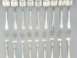 a lot of silver spoons and forks on the table