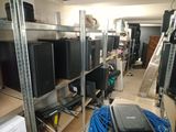 many televisions and other electronics in a room