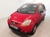 a red car that is parked in a room