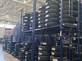 a lot of tires stacked on a rack in a warehouse