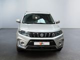 the front view of a white suzuki suv parked in a room