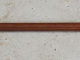 a close up of a metal and wood handle on a wooden surface