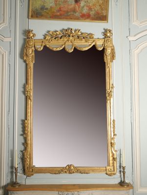a mirror that is on a mantle in a room