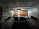 a white van that has two doors open and two windows closed