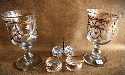 two glass goblets sitting next to each other on a table