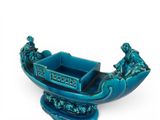 an image of a blue boat with people on it on a white background