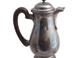 a silver coffee pot with a handle on a white background