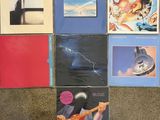several albums of various music are arranged on the floor