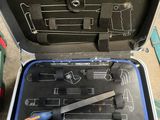 a suitcase with tools in it sitting on the floor