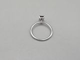 a close up of a silver ring on a white surface