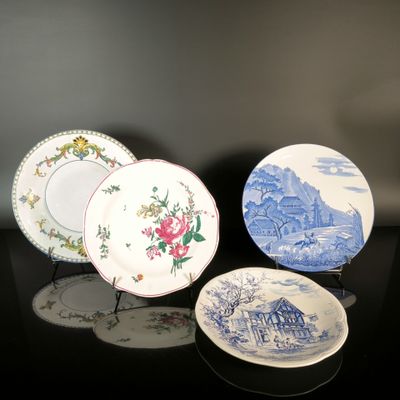 three plates with blue and white designs on them sitting on a table