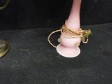 a pink vase with a rope wrapped around it