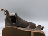 the shoe is made of sued and has a brown sole