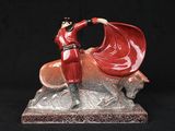 figurine of a woman in a red dress on a horse