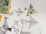 a lot of toy airplanes that are on the table