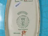 a small plate with a stamp on it on a blue table