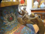 a close up of a vase with a dragon head on it