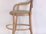 a wooden chair that is sitting on a white surface