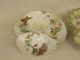two plates with flowers on them sitting on a table