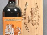 a bottle of red wine next to a wooden box