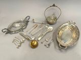 a silver plate with spoons, spoons and other silverware on it