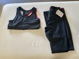 two pieces of clothing are laying on a bed next to each other