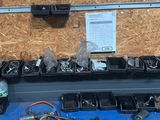 several trays of assorted electronics are on a table