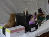 several pairs of women ' s shoes are on a table with boxes